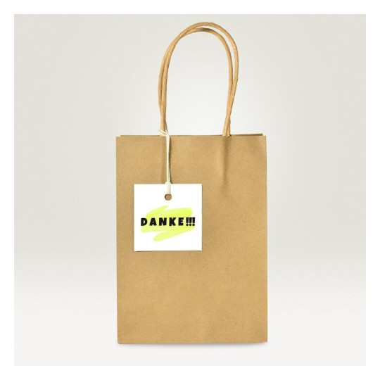 Una bolsa de papel marrón con un asa y una etiqueta que dice 'DANKE!!!' en letras grandes.