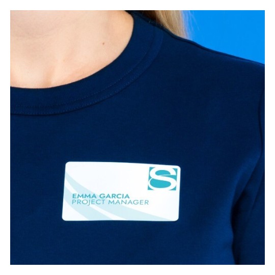 En la imagen se muestra a una persona que lleva una camiseta de color azul marino con una etiqueta en el pecho que dice 'Emma Garcia, Project Manager'.
