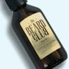 frasco de cristal con barba cosmética con etiqueta adhesiva dorada
