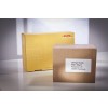 En la imagen se pueden ver dos cajas de envío, una amarilla de DHL y una marrón con una etiqueta que contiene una dirección específica.